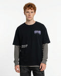Person wearing a black t-shirt with text and graphics on a white background
