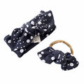 Handmade polka dot headbands for babies and toddlers, featuring a stylish black and white design. Includes a top knot headband and a bow on nylon, perfect for everyday wear or special occasions. Comfortable and adorable accessory for little ones.