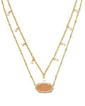Two gold necklaces with a central peach-colored stone and small pearls on a white background