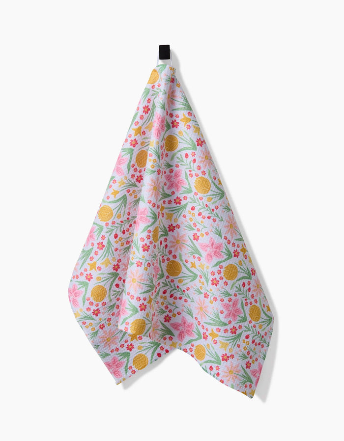 Floral patterned towel hanging on a white background