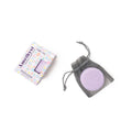 A shower steamer bag with a purple steamer visible through the mesh, alongside its packaging box with 'Cait + Co. Gem Shower Steamer - Amethyst' written on it.