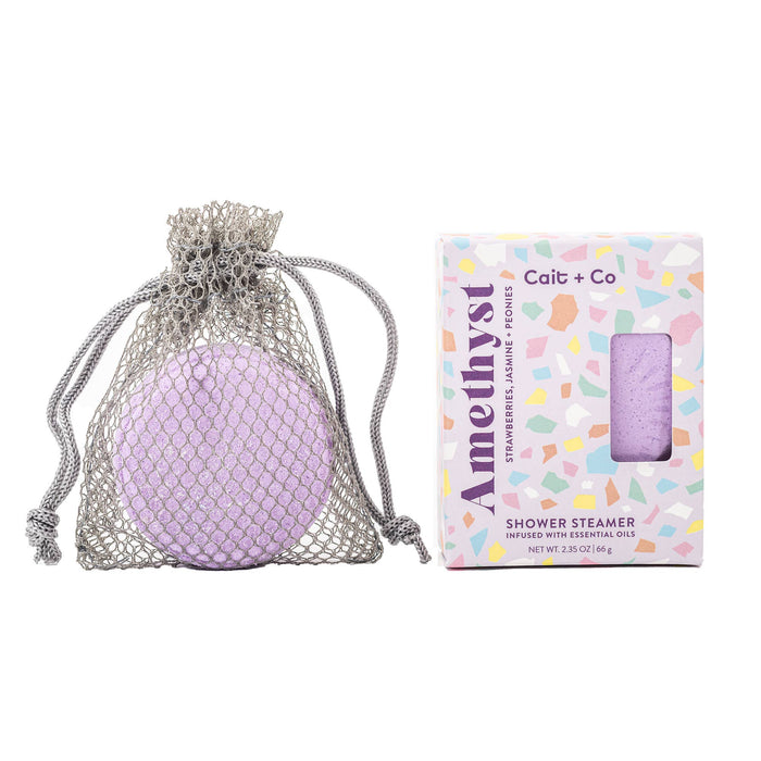 Amethyst shower steamer and its packaging against a white background