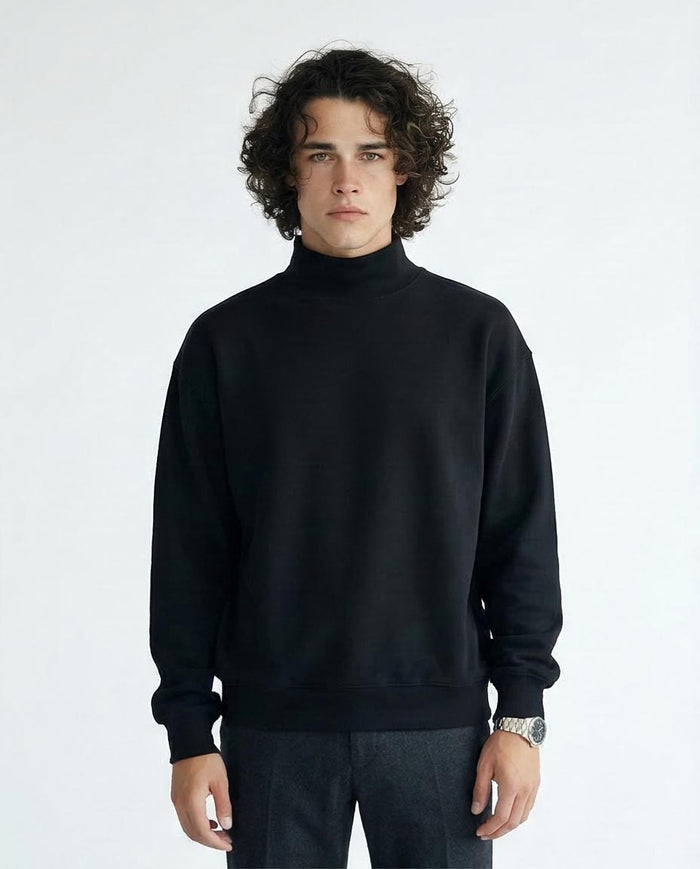 Man wearing a black turtleneck sweater against a white background