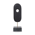 The monolithium shape is executed in ground black marble and polymers with a honed black marble base and brass pegs.