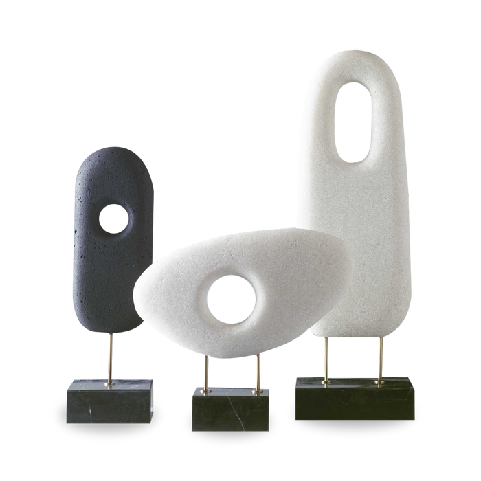 The monolithium shape is executed in ground black marble and polymers with a honed black marble base and brass pegs.