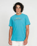 Man wearing a blue t-shirt with visible branding against a plain background