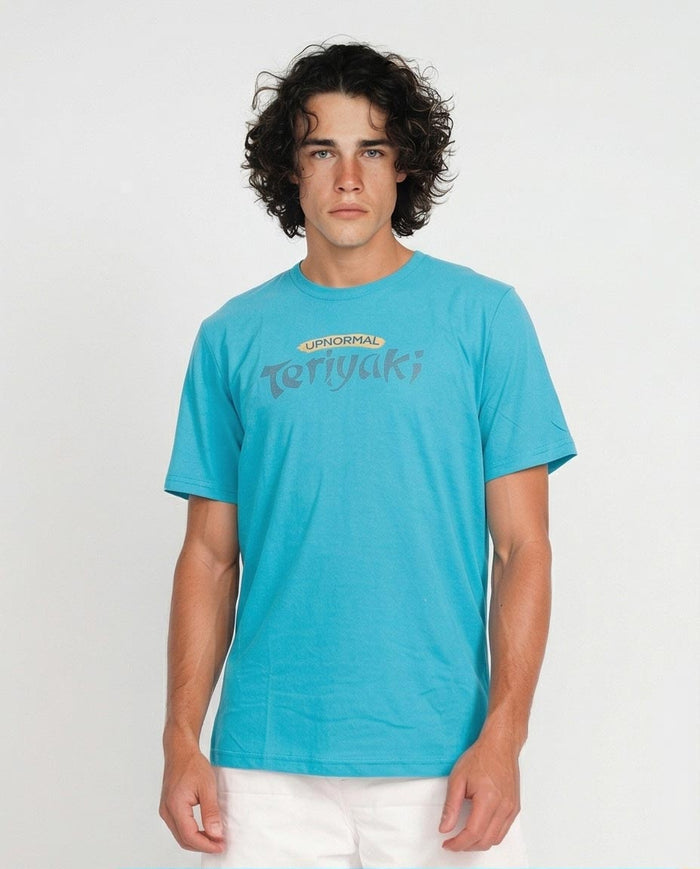 Man wearing a blue t-shirt with visible branding against a plain background