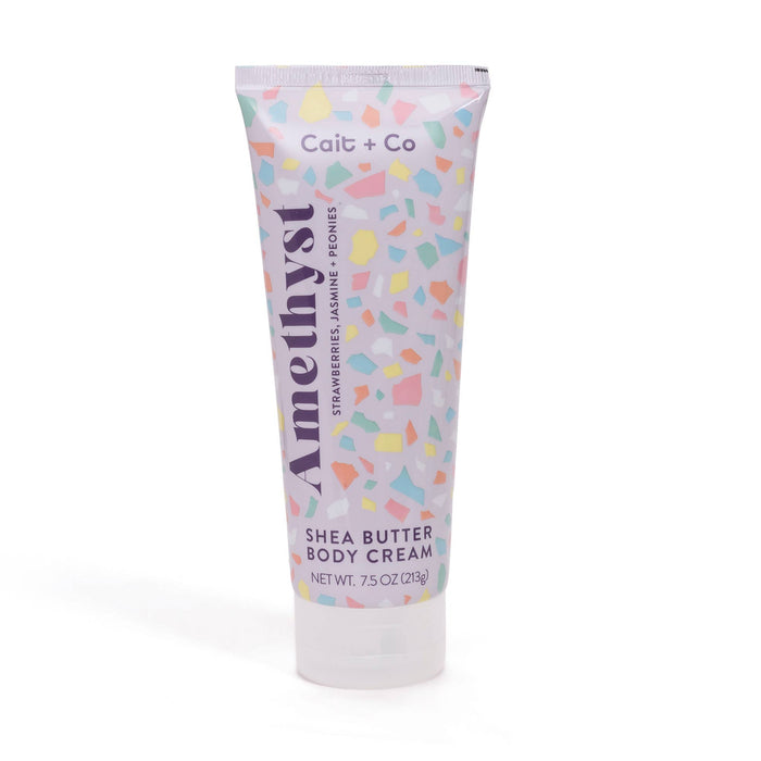 A tube of Cait + Co Shea Butter Body Cream with a colorful geometric pattern on the label.