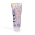 A tube of Cait + Co Shea Butter Body Cream with a colorful geometric pattern on the label.