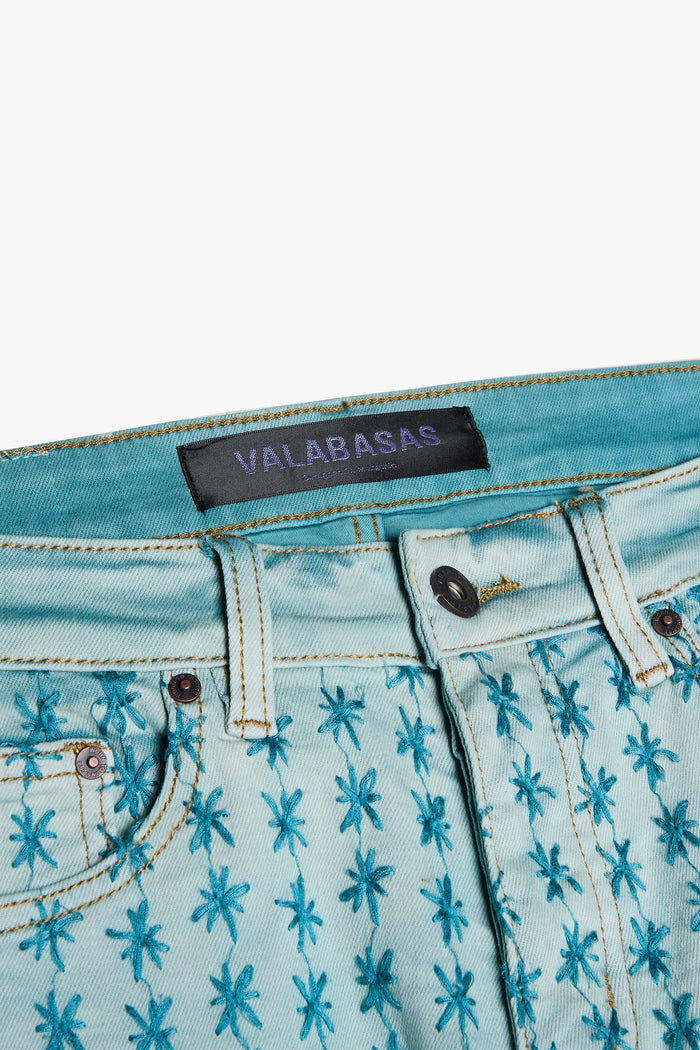 Valabasas Asterisk Light Blue/Blue Stacked Flare Jeans styled with white sneakers and a crop top